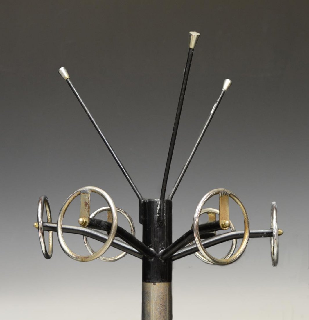 ITALIAN ART DECO CHROMED STEEL & BLACK HALLTREE: Italian Art Deco chromed steel hall tree, c. 1930's, six circular hooks on the cylindrical standard, above a circular ring and tray accommodating umbrellas, the whole on black legs, approx 73"h Start 