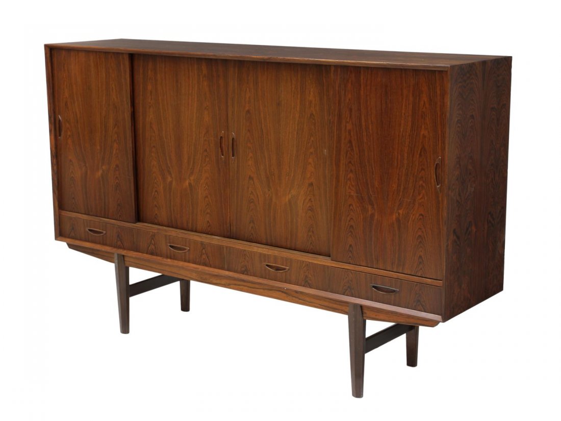 DANISH MID-CENTURY MODERN ROSEWOOD SIDEBOARD: Danish mid-century modern sideboard, upper section having four sliding doors opening to shelved interior to the left and four drawers with mirror to the right, base having four drawers, rising on shap