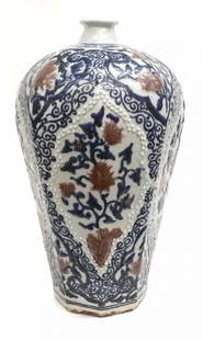 CHINESE ENAMELED PORCELAIN OCTAGONAL VASE: Chinese white, blue and red porcelain octagonal vase, raised floral reserves surrounded by enamel scrolled tendrils, wax seal underfoot, approx 17.25"h, 10lbs Start Price: $150.00