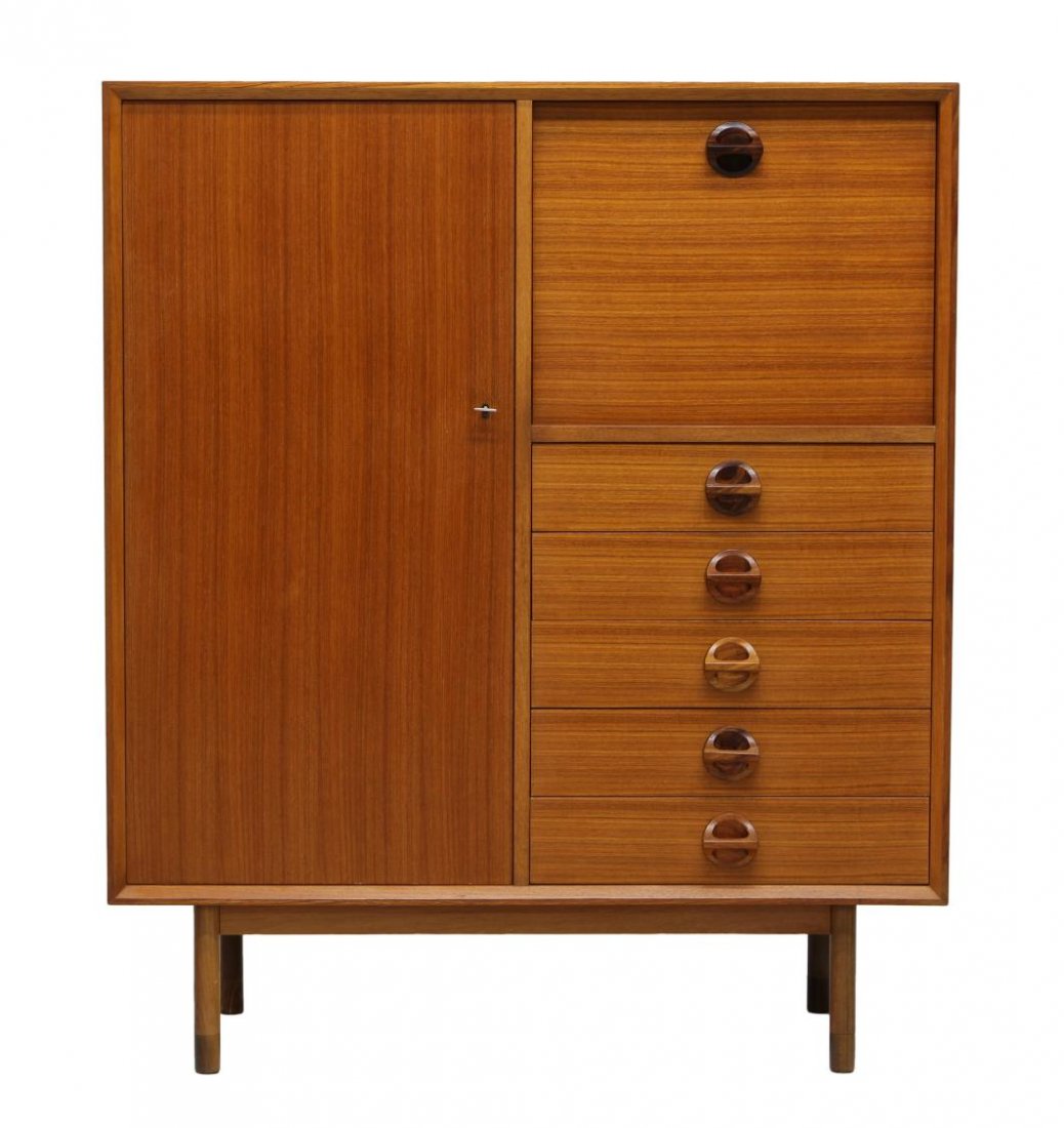 MID-CENTURY MODERN TEAKWOOD CABINET: Teakwood mid-century modern cabinet, 1960's, retaining Chiavari, Italy tag verso, rectangular with a full length door at one side opening to shelved storage, a drop front laminate writing surface at t
