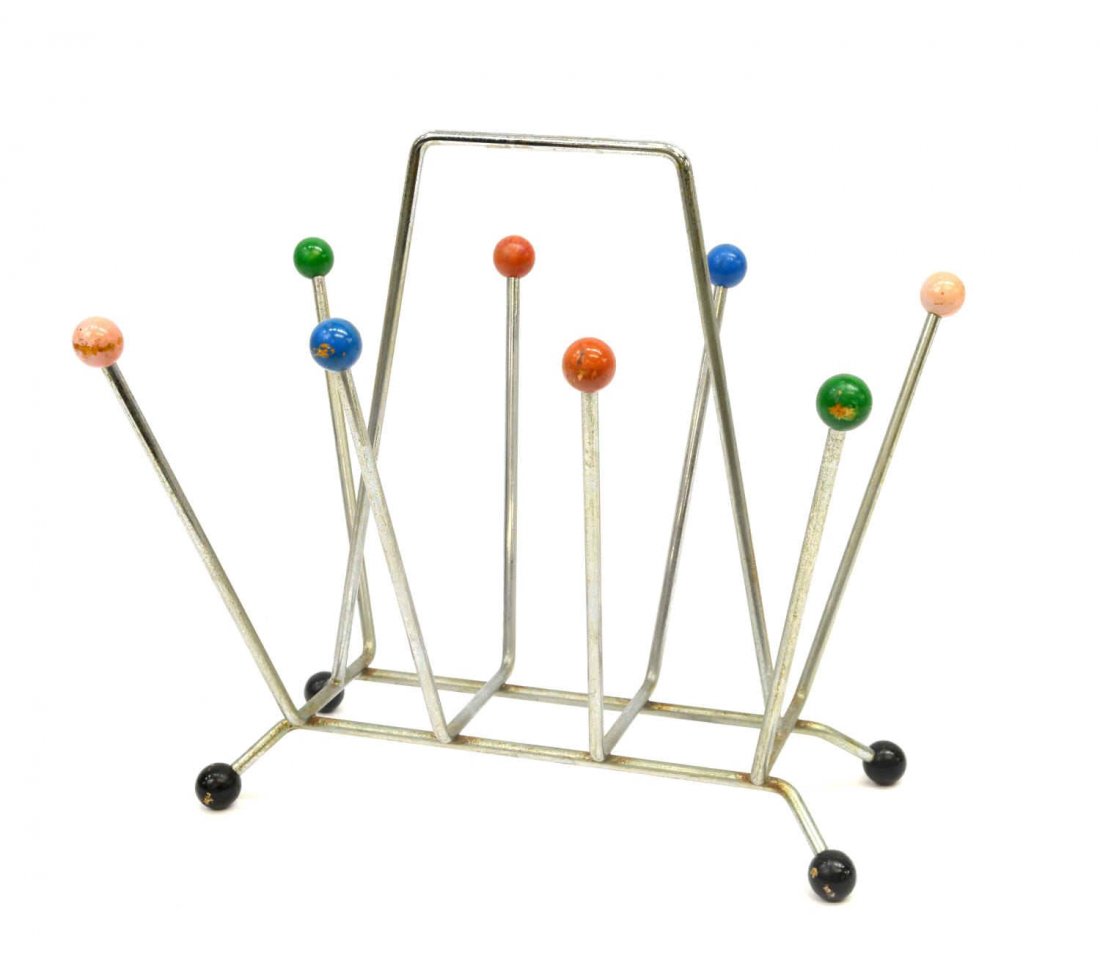 ITALIAN MID-CENTURY MODERN CHROMED MAGAZINE RACK: Italian mid-century modern chromed steel magazine rack, c. 1960's, colored ball finials on chromed steel frame, raised on four black ball feet, some rust / oxidation to frame, approx 14.25"h, 15.5"l, 