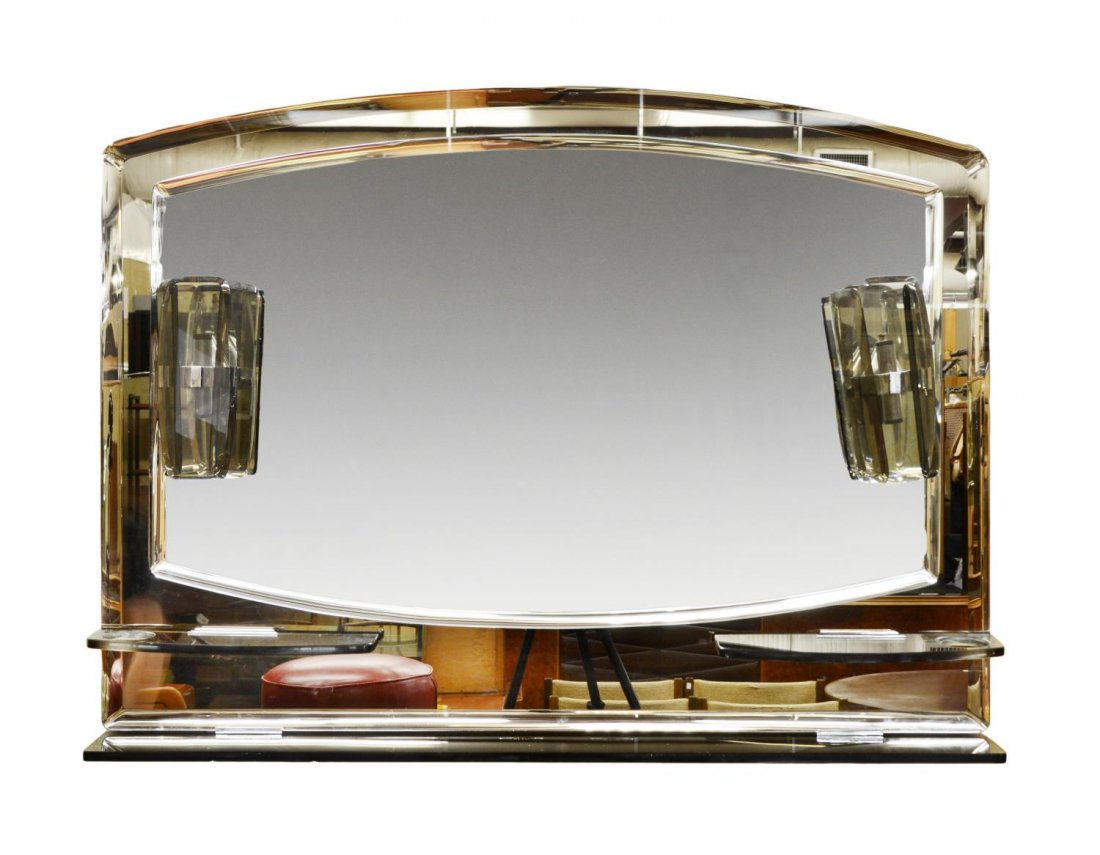 ITALIAN COLORED MURANO GLASS VANITY WALL MIRROR: Italian modern Murano art glass vanity wall mirror, c.1960, central mirror plate having beveled edges mounted on tinted mirror plate, flanked by two-light sconces over small glass shelves, full length
