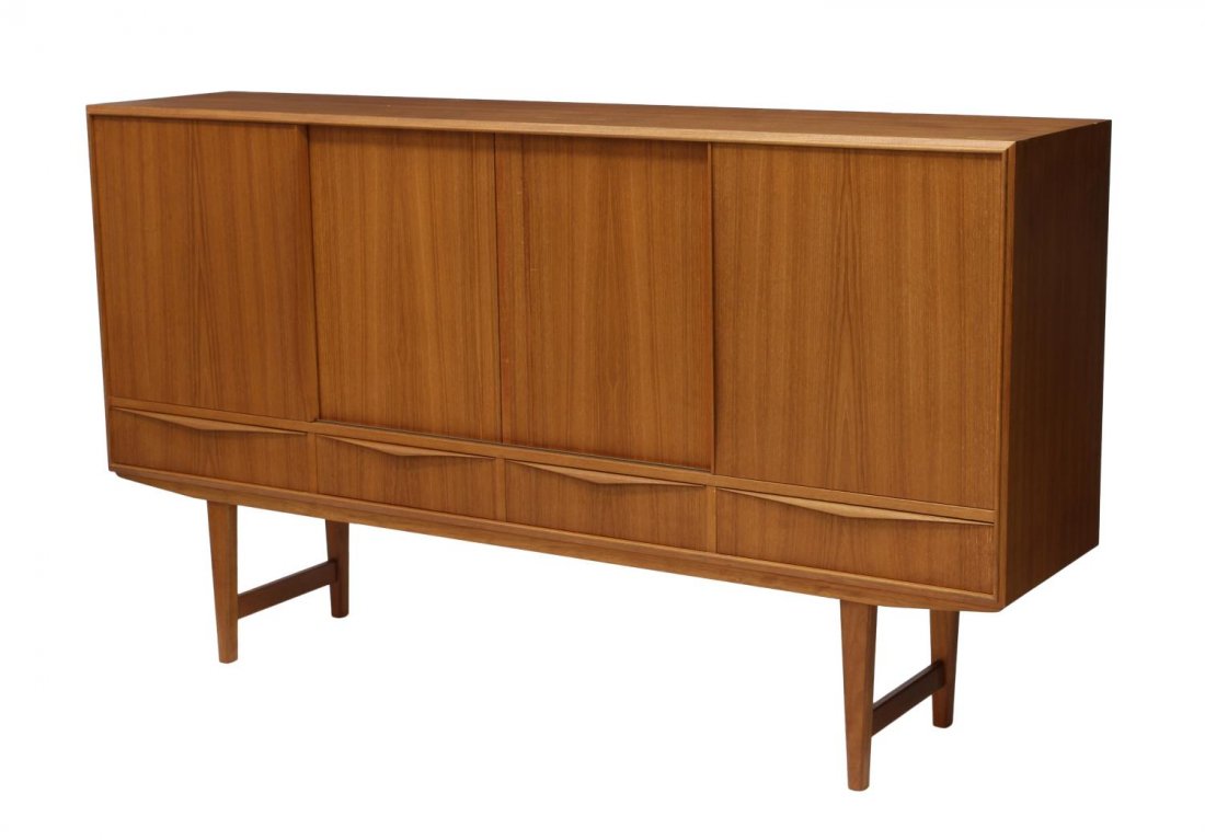 DANISH MID-CENTURY MODERN TEAKWOOD SIDEBOARD: Danish mid-century modern teakwood sideboard, 1950's, having sliding doors opening to interior shelves and a compartment with mirror and two silver drawers, four lower exterior drawers, rising on stre