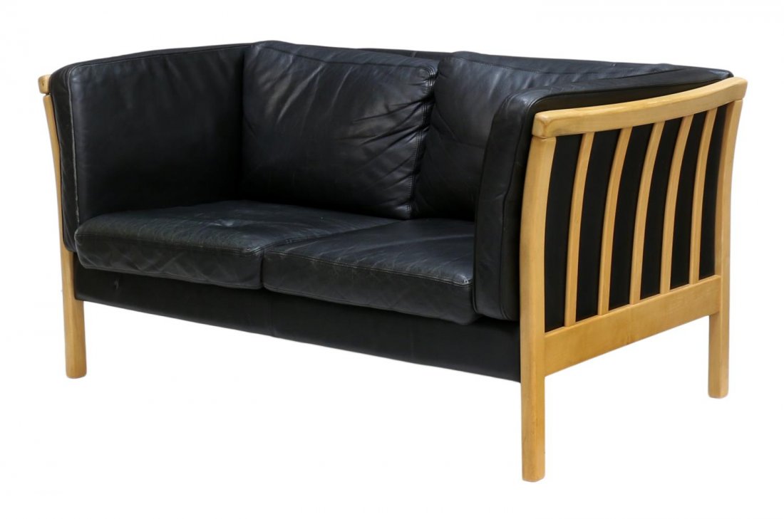 DANISH MID-CENTURY MODERN BLACK LEATHER SOFA: Danish mid-century modern black leather upholstered sofa, c. 1950/60, design by Stouby Furniture Company, a wood frame around the two seat sofa, removable cushions, wear to leather, approx 30.25"h, 57