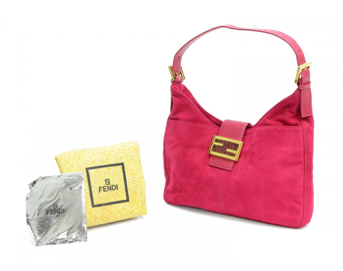 FENDI FUSCHIA PINK SUEDE SHOULDER BAG: Fendi shoulder bag in fuschia pink suede and gold tone hardware, red fabric interior with two compartments and one side zipper pocket, single flap with red glitter enamel to logo and magnetic snap clo