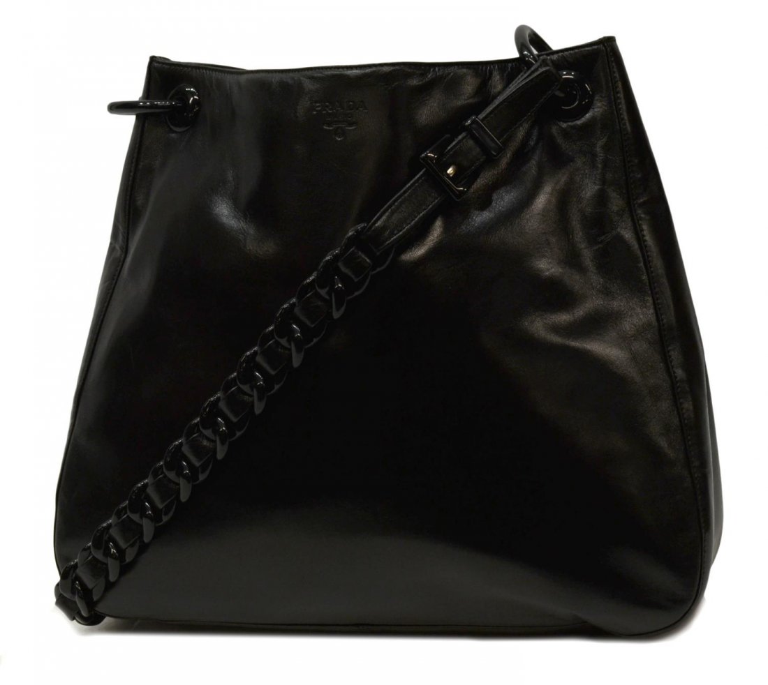 PRADA BLACK LEATHER & BAKELITE SHOULDER BAG: Prada black leather shoulder bag having woven leather and bakelite chain strap, impressed Prada Milano to upper center, interior logo liner with zip pocket, retaining authenticity card dated 1997, bag