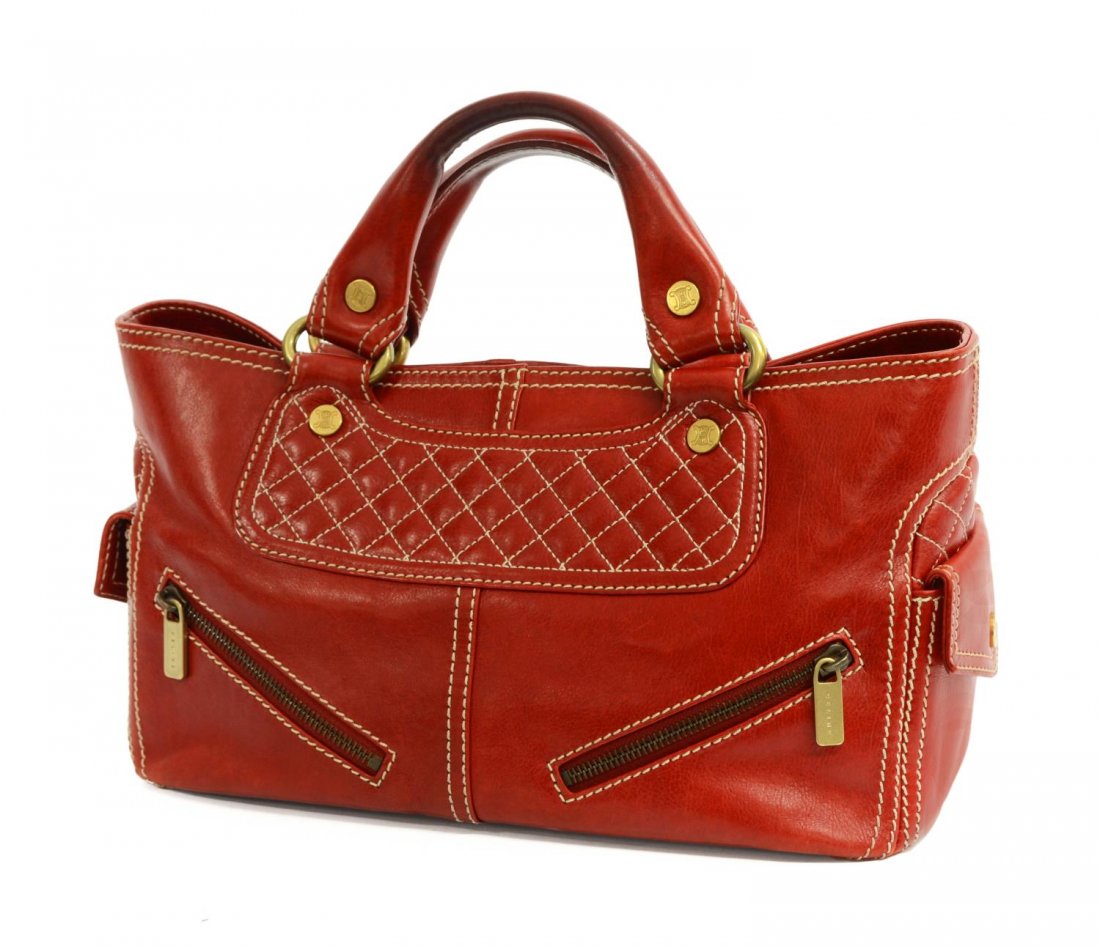CELINE RED LEATHER BOOGIE BAG PURSE: Celine "Boogie" bag in red leather with cream stitching, dual handles, exterior with snap pockets to either end, zippered pockets to one side, interior having open slot pockets, central zipper pocket,