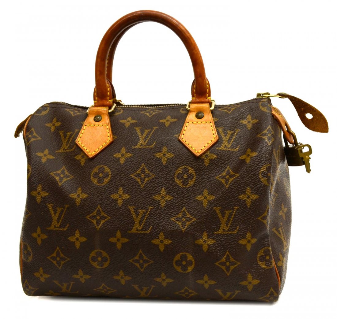 LOUIS VUITTON MONOGRAM CANVAS SPEEDY HANDBAG: Louis Vuitton "Speedy 25" handbag in monogram canvas, leather handles, piping and trim, gold tone hardware, single zip top opening to brown cloth interior with slot pocket, LV lock and key, patination