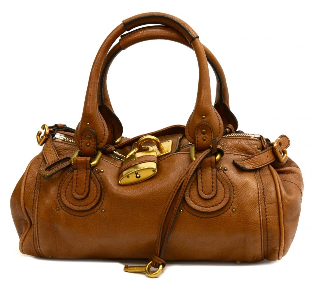 CHLOE PADDINGTON MM BROWN LEATHER LOCK PURSE: Chloe "Paddington" in brown leather with gold tone hardware, two exterior slot pockets, top unzips to tan cloth lined interior featuring slot and zipped pockets, on small metal feet, with signature lo