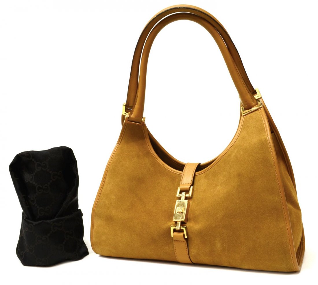 GUCCI TAN SUEDE & LEATHER HANDBAG: Gucci handbag in tan suede and leather with gold tone hardware, brown fabric interior with one side zipper pocket, single piston closure, accompanied by dust bag, bag approx 8.5"h, 12"w, 4"d, 1.25lbs 