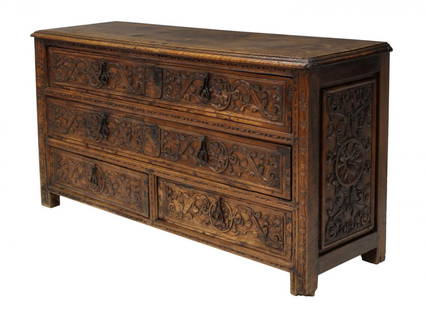 SPANISH 18TH C. CARVED VESTMENT CHEST: Religious vestment chest, Spain, 18th c., walnut like wood, the face and raised sides with foliate relief carving, two long drawers with original locks over two short drawers, rising on short straight