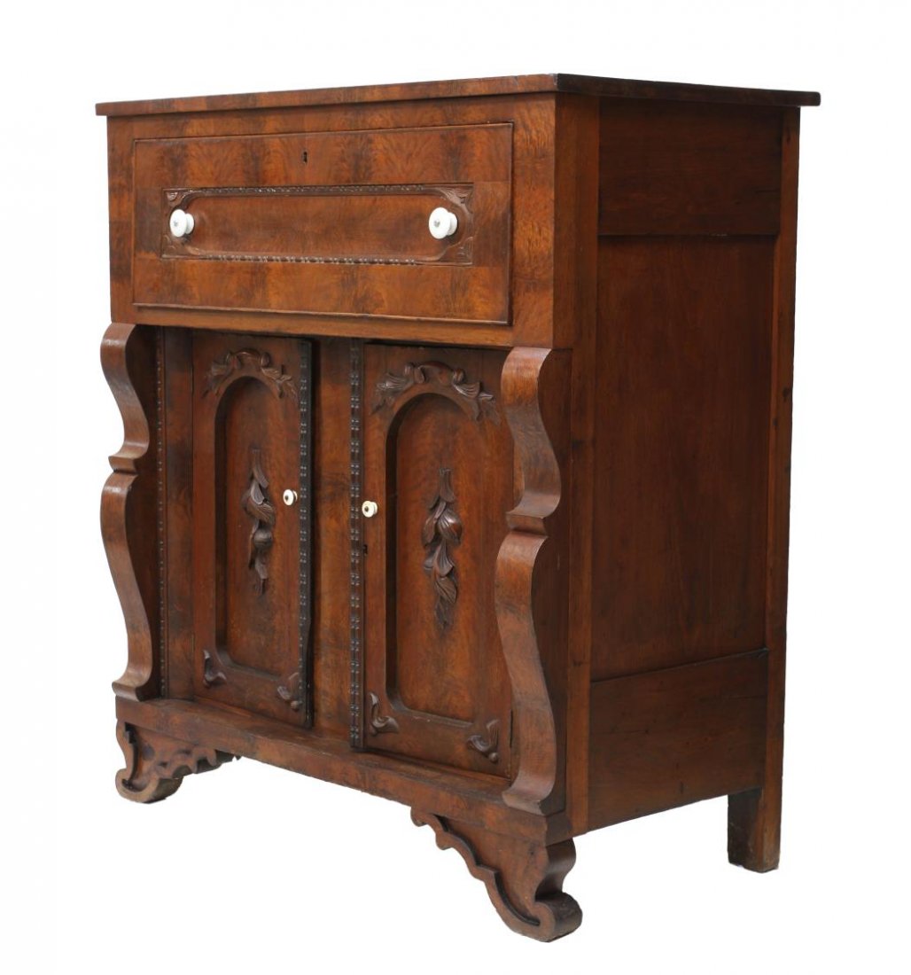 AMERICAN MAHOGANY BUTLERS DESK: American Empire mahogany butlers desk, 19th c., an upper drawer that opens to a writing surface and gallery fitted with drawers and slots, two lower doors flanked by scrolled columns, rising on shaped