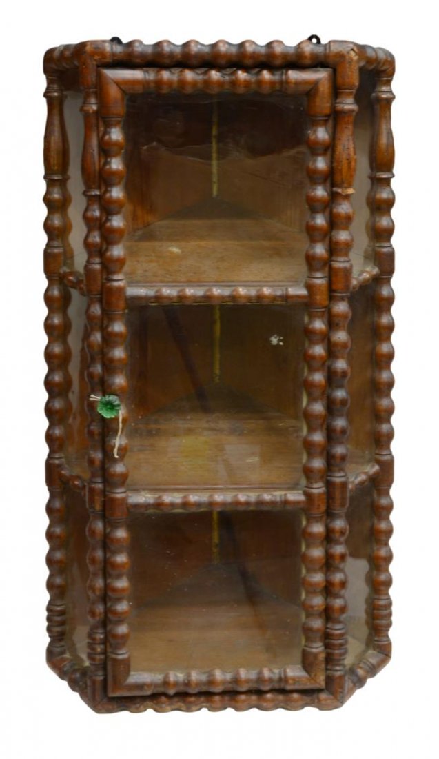 HANGING SPOOL FRAMED CORNER CABINET: Hanging spool framed corner cabinet with glass panes, interior shelves and green glass pull, 37"h, 18.5"w, 13.75"d (3002) *Provenance: Estate of Howard Hand (Texas, New York, 1921-2011). A collector a