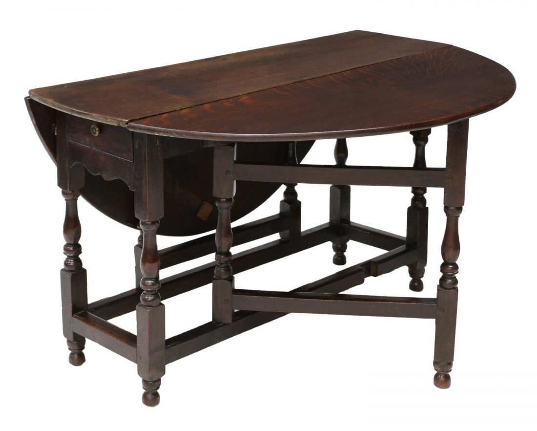 LARGE ENGLISH OAK DROP LEAF TABLE: Large English oak gateleg drop leaf table opening to an oval form 52"l, 20th c., one end with a drawer, rising on stretcher joined turned supports, 28.75"w, 15.75"d, 49"d (2011) *Provenance: Estate of
