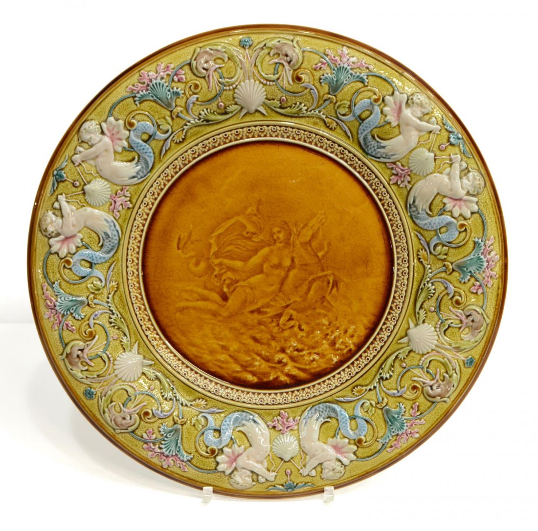 LARGE METTLACH MERMAID EARTHENWARE CHARGER, 1110: German Mettlach porcelain charger, rim featuring raised mermaid and bird motif with scrolling foliate accents, central figural reserve depicting semi-nude beauty on the back of a hippocampus, castle a