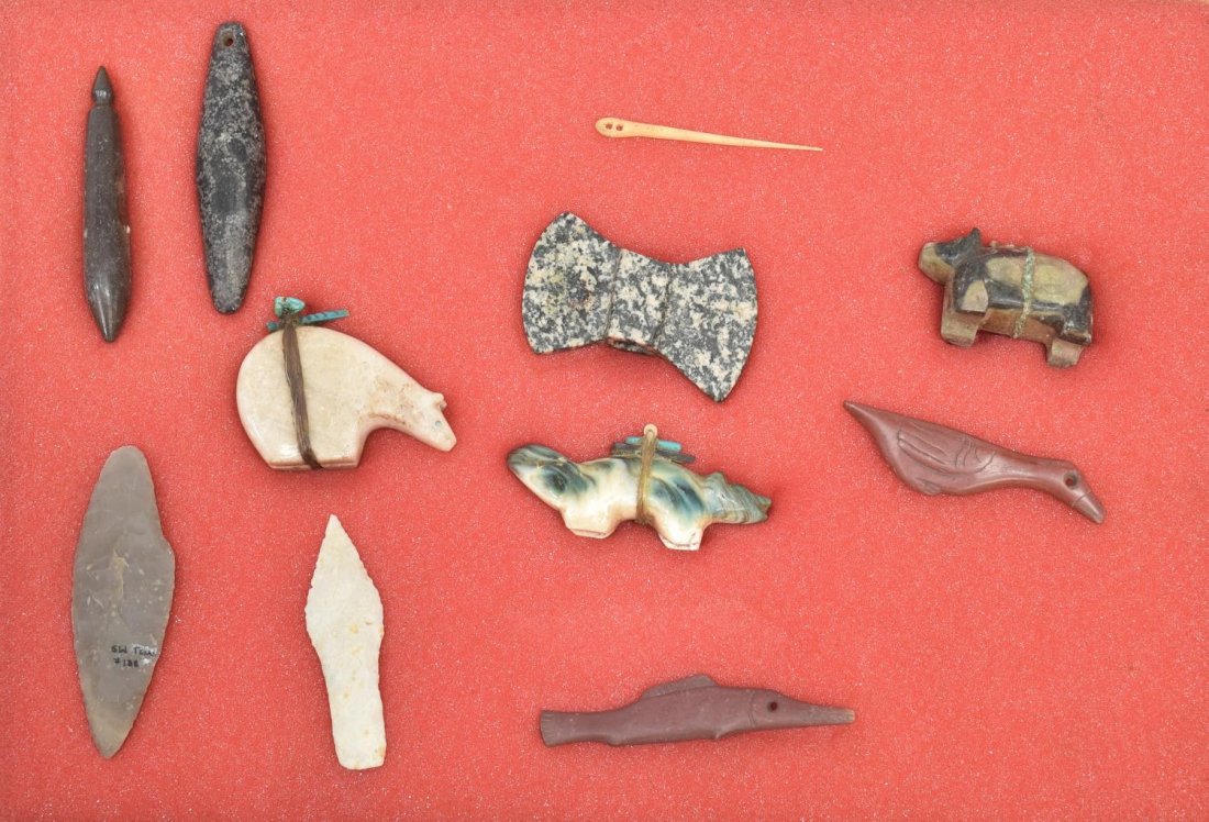 (11) AMERICAN INDIAN CARVED STONE FETISHES: (lot of 12) Native American carved stone items: (2) arrowheads, one marked S.W. Texas, largest 4"l; (1) carved stone Polar bear with turquoise items on back, 3"l; (1) carved stone wolf or bear with tu