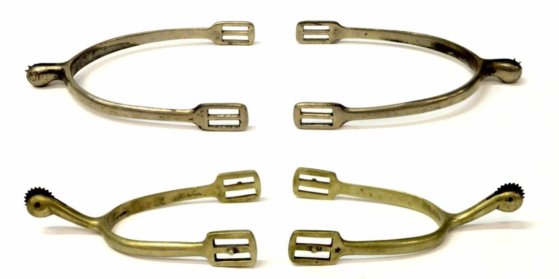 (TWO PAIR) CAVALRY SPURS, ONE BUERMANN: (two pair) Cavalry spurs: (1 pair) with Buermann inset star, further marked 'solid nickel', inside yoke: approx. 3"w, 3.75"d, 1lb; (1 pair), difficult to read number mark possibly 106, inside yoke: ap