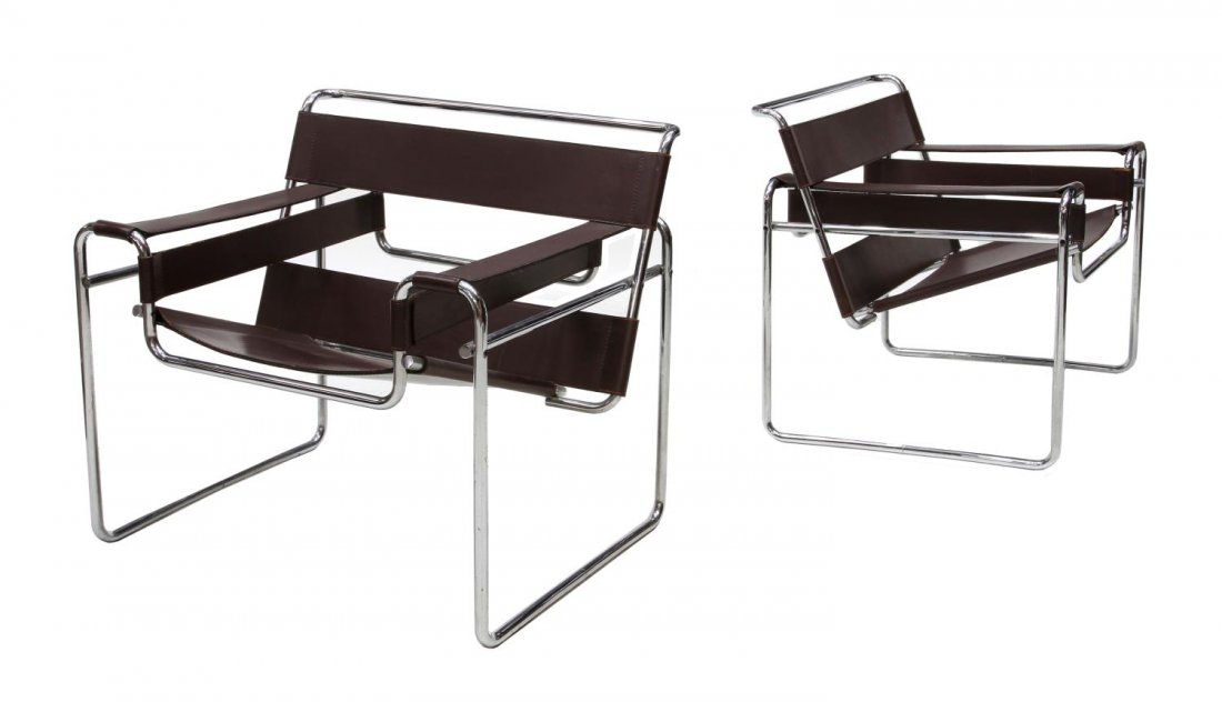 KNOLL, MARCEL BRUER, CHROME 'WASSILY' CHAIRS: (lot of 2) Knoll 'Wassily' tubular chrome steel framed chairs, 1925 design by Marcel Bruer (Hungary, New York, 1902-1981), the seat, strap back, and strap arms in brown leather, one retaining shipping