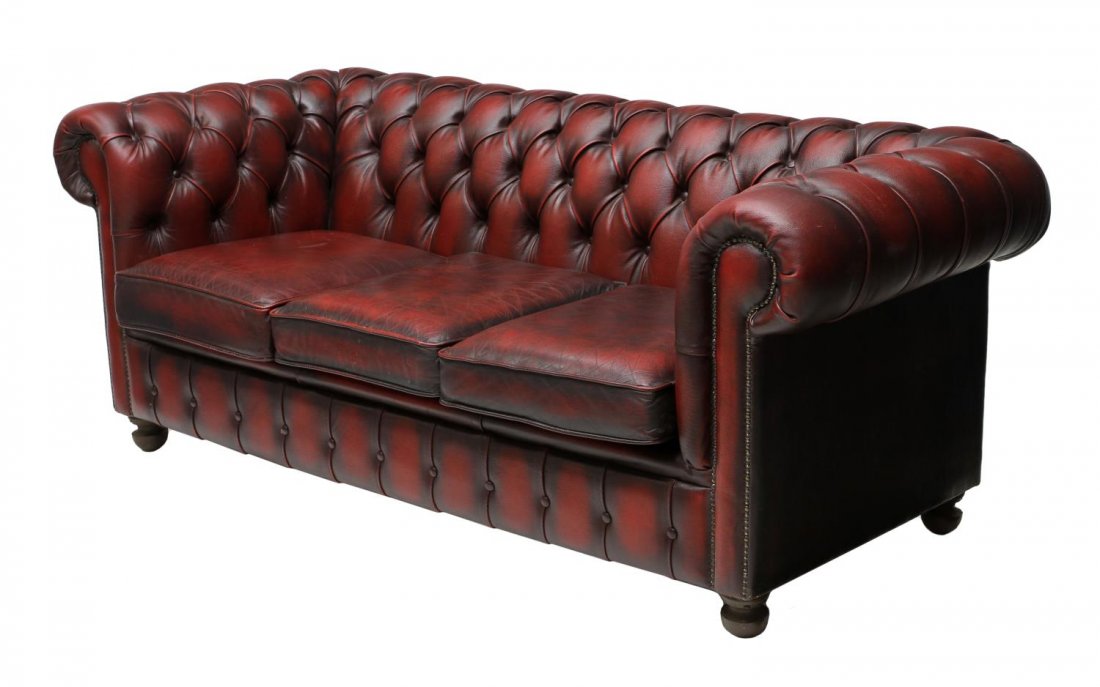 ENGLISH CHESTERFIELD BUTTONED RED LEATHER SOFA: English Chesterfield buttoned sofa in oxblood red leather, rising on ball feet, approx 30"h, 76"l, 33"d (221) Start Price: $400.00