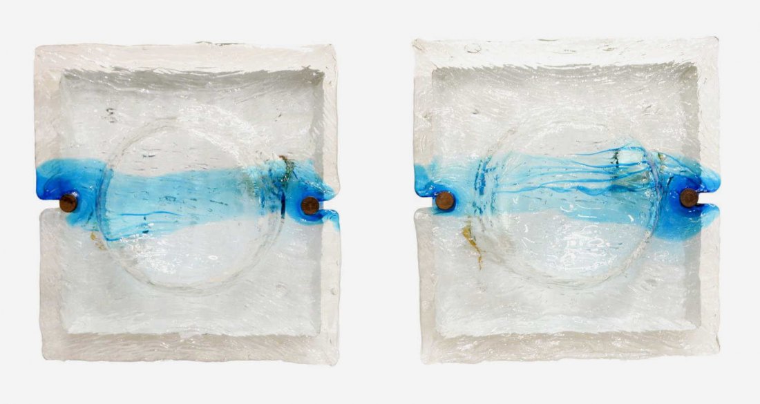 (pair) ITALIAN MODERN VENINI TWO-LIGHT WALL SCONCE: (pair) Italian modern Venini two-light wall sconces, c.1970, hand formed textured clear glass shade with blue accent mounted on white enamel metal wall plate, in need of wiring, minor wear to wall pla