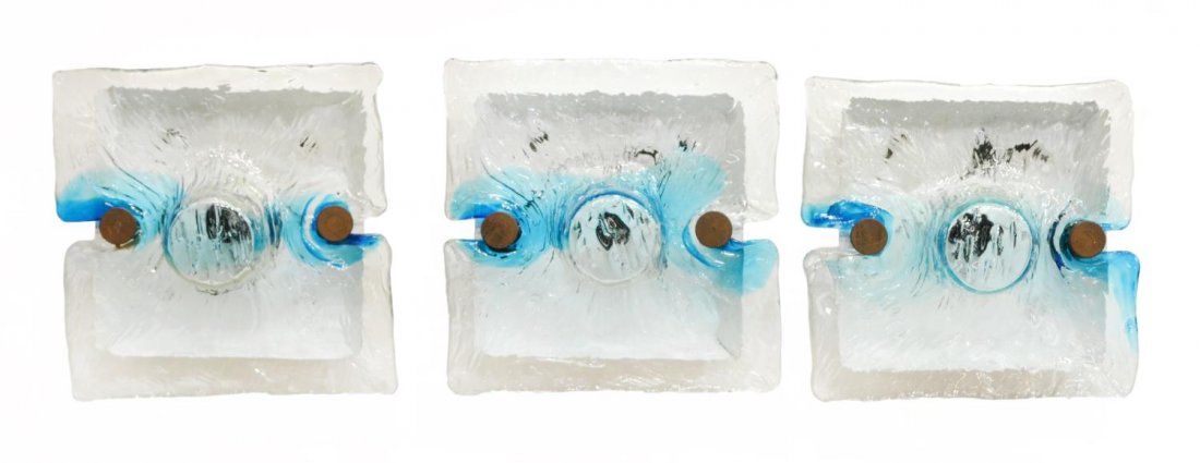 (3) ITALIAN VENINI SINGLE LIGHT WALL SCONCES: (lot of 3) Italian modern Venini single-light wall sconces, c.1970, hand formed textured clear glass shade with blue accent mounted on white enamel metal wall plate, in need of wiring, minor wear to w