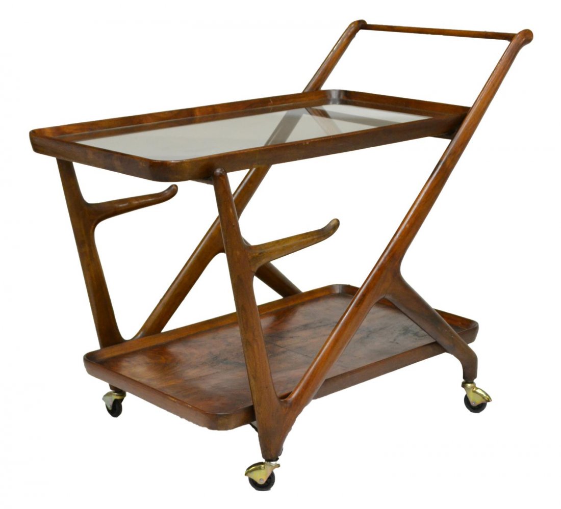 CASSINA ITALIAN MID-CENTURY MODERN SERVICE TROLLEY: Italian mid-century modern service trolley, c.1960, design by Cassina, wood frame with one glass shelf and lower wood shelf, rising on casters, approx 28"h, 33.5"l, 17.25"w Start Price: $150.00