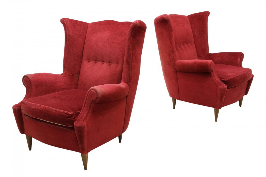 (2) ITALIAN MID-CENTURY MODERN WINGBACK CHAIRS: (pair) Italian mid-century modern wingback chairs, 1950's, upholstered in buttoned red fabric, the arched high back over a loose cushion seat flanked by arms, rising on turned tapered legs, 40"h, 32"w