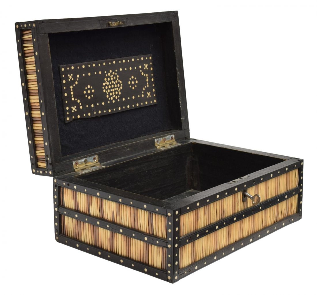 ANGLO-INDIAN INLAID PORCUPINE QUILL BOX: Anglo-Indian ebonized porcupine quill box of rectangular form, the hinged lid having wood strapping with inlaid bone dots, opening to reveal storage and central inlaid plaque, 5.25"h, 10.75"l, 5.5"w, 