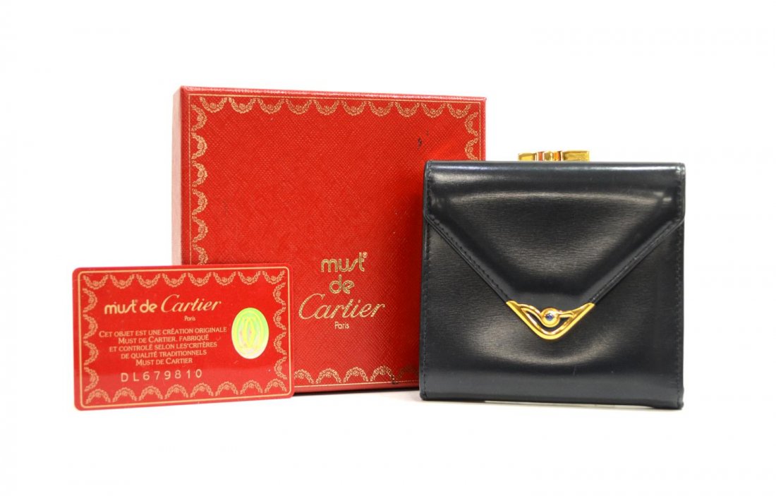 CARTIER SQUARE NAVY BLUE WALLET: Cartier square wallet in navy blue leather with gold tone hardware, interior having card slots and compartments, back exterior having snap lock coin pocket, accompanied by card of authenticity and box