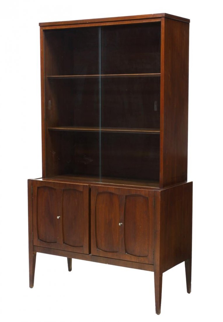 MID-CENTURY MODERN DISPLAY CABINET: American mid-century modern china display cabinet, 1950's, the upper section with sliding glass doors opening to shelves, the lower section with two panel front doors, rising on tapered squared legs, 