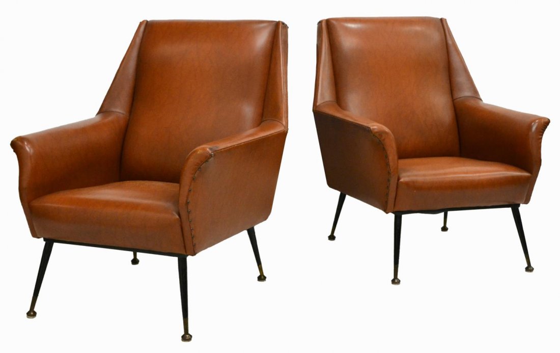 ITALIAN MID-CENTURY UPHOLSTERED ARM CHAIRS, 1950S: (pair) Italian mid-century modern armchairs, c. 1950s, having brown faux leather upholstery with nail head trim, black tapered legs, brass feet, 33"h, 27.5"w, 26"d Start Price: $400.00