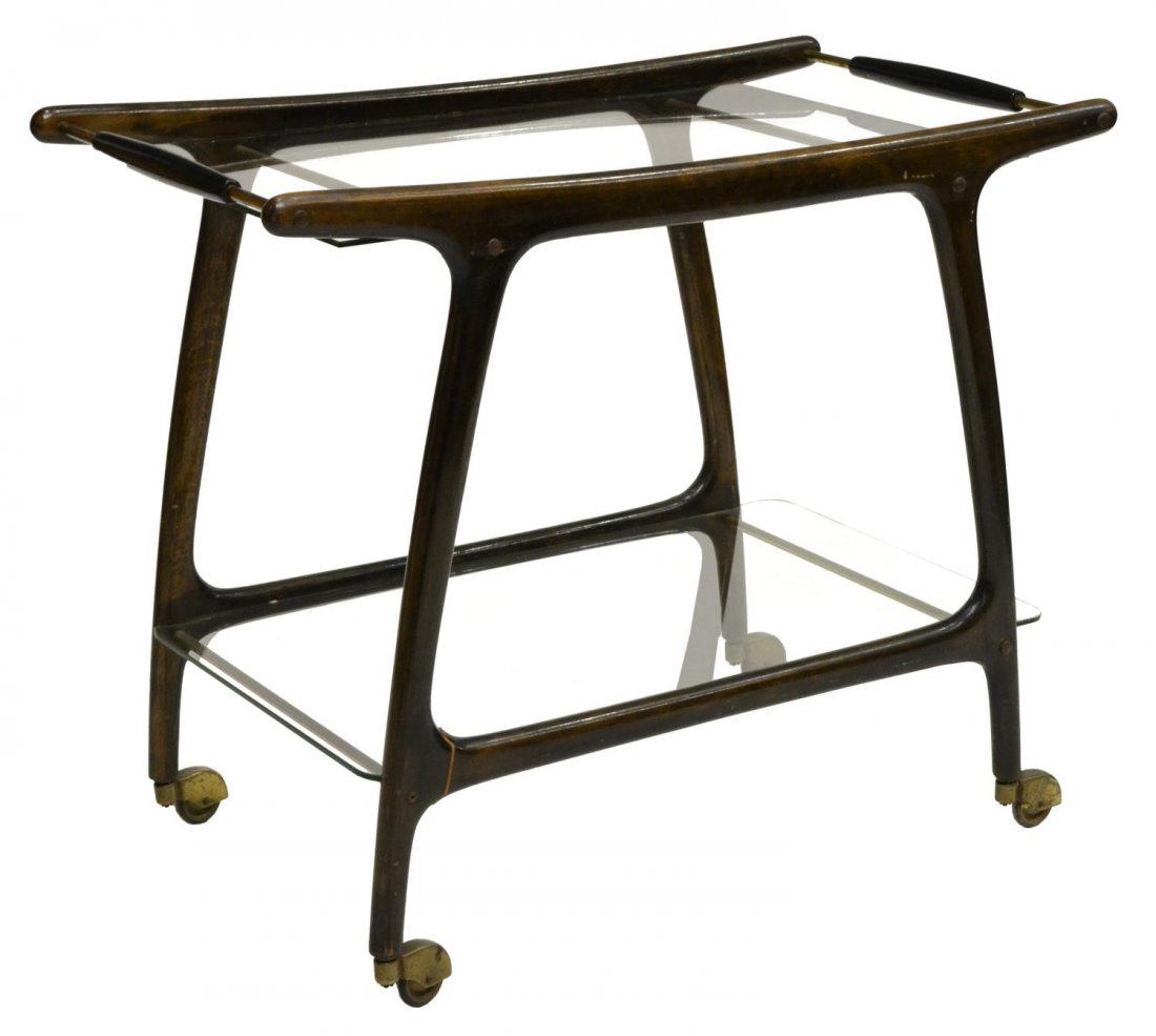 ITALIAN CASSINA GLASS TOP SERVICE CART, C. 1950: Italian service cart, c. 1950, design by Cassina, the glass top above a glass shelf, in wooden frame, rising on tapered legs, with castors, 36"h, 31.5"w, 17.25"d Start Price: $200.00