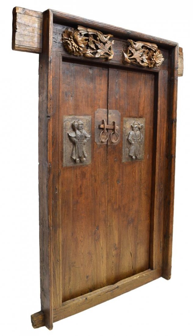 CHINESE ELMWOOD DOORS, FIGURAL IRON ACCENTS: Chinese elmwood door set, 19th c., two doors with iron lock plates, inset decorative iron guard figures, removable from the elmwood frame with long headboard, door frame: approx. 79.25"h, 62"w, 7"d, e