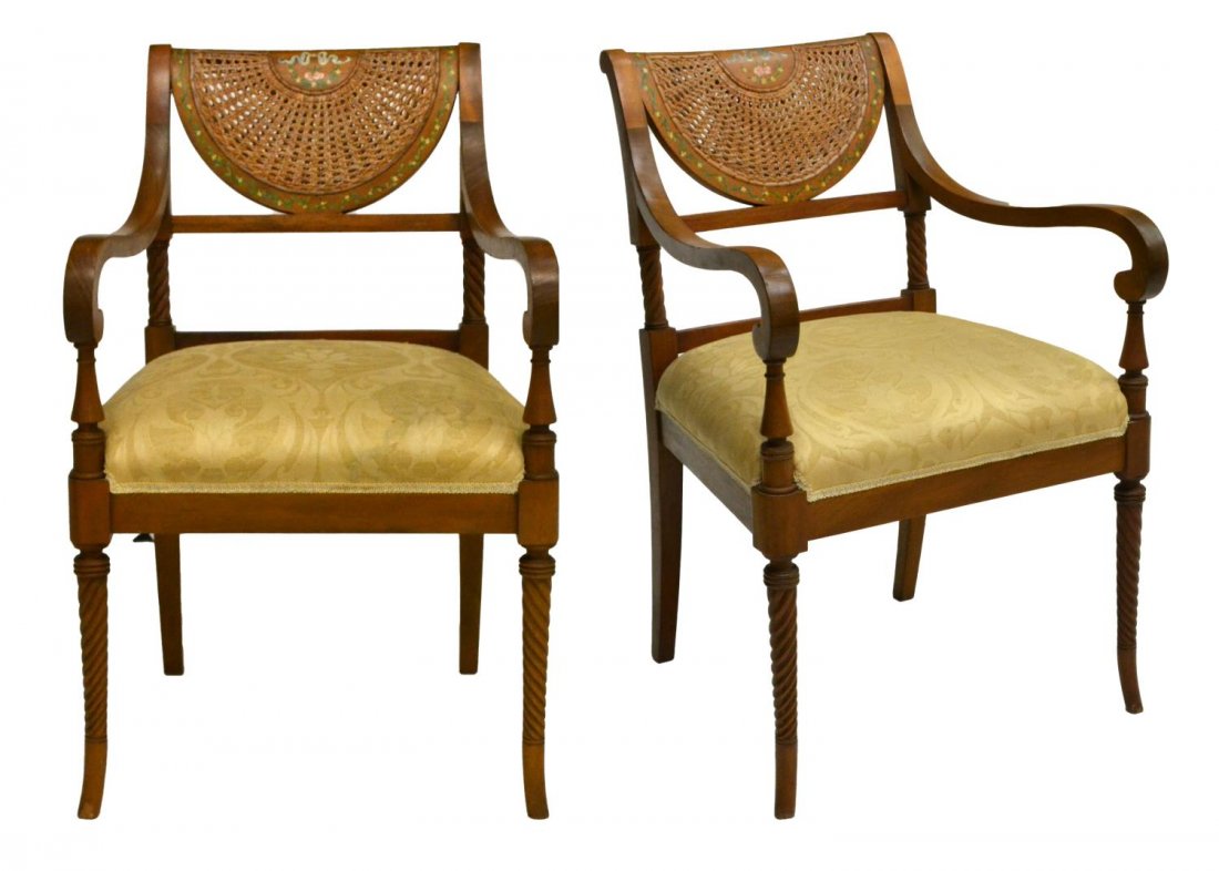 (2) SHERATON STYLE DEMILUNE CANE BACK ARMCHAIRS: (pair) Sheraton style armchairs, 20th c., having a demilune cane back accented with painted floral design, the armrests terminating in scroll form handholds, turned accents around upholstered seat, ri