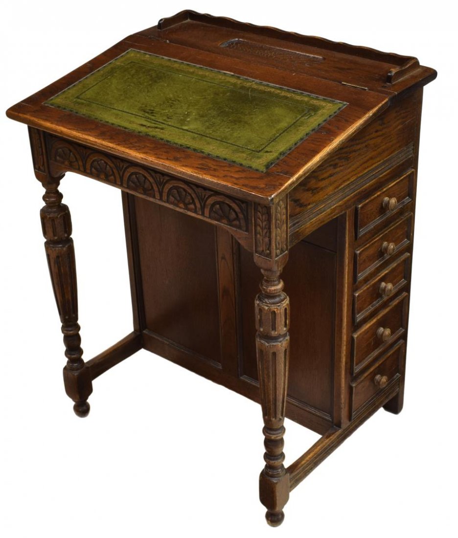DAVENPORT DESK BY ETHAN ALLEN: Davenport desk by Ethan Allen, the oak structure having a gallery top with pen rest, with a leather topped lid opening to reveal compartments, five drawers at right side, rising on turned and carved c