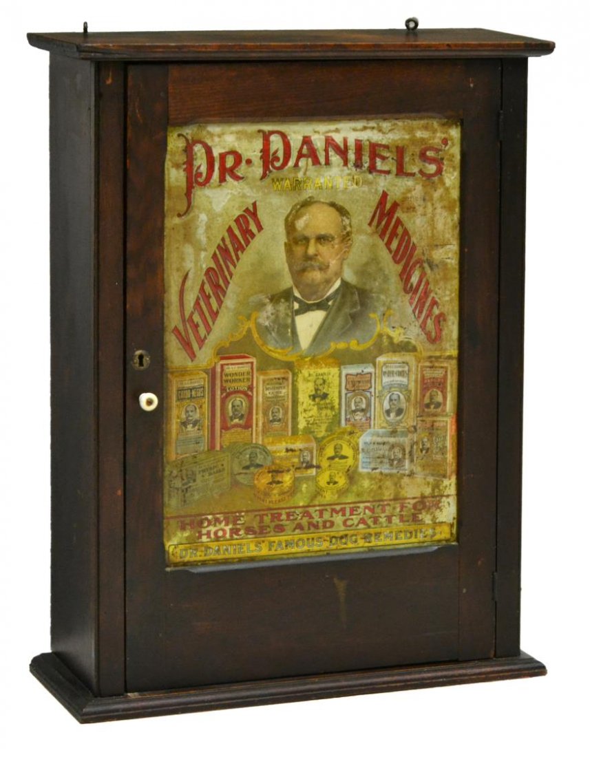 OAK WALL CABINET, METAL ADVERTISING SIGN DOOR: Oak wall cabinet, late 20th c., the door inset with a reproduction advertising sign "Dr. Daniels, Veterinary Medicines", 28.75"h, 21.5"w, 7.5"d Start Price: $60.00