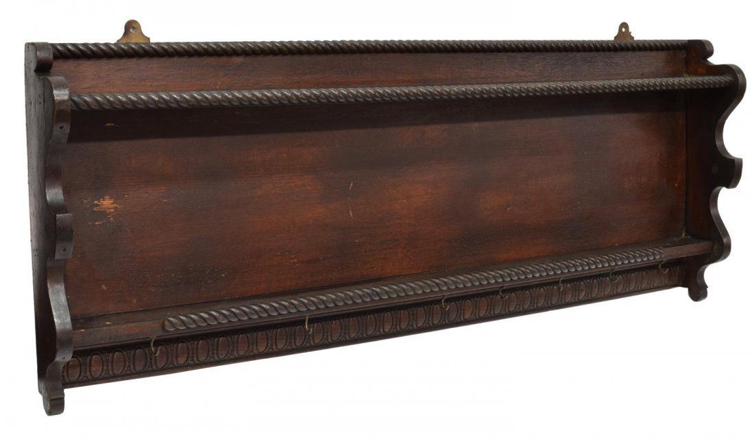 ANTIQUE CARVED TWO-SHELF HANGING WALL UNIT: Antique carved two-shelf hanging wall unit, the shelves with gadrooned details over a band of carved cartouches, with a row of hanging hooks, lacking two hooks, 17"h, 42"w, 4"d *Provenance: Estate of 