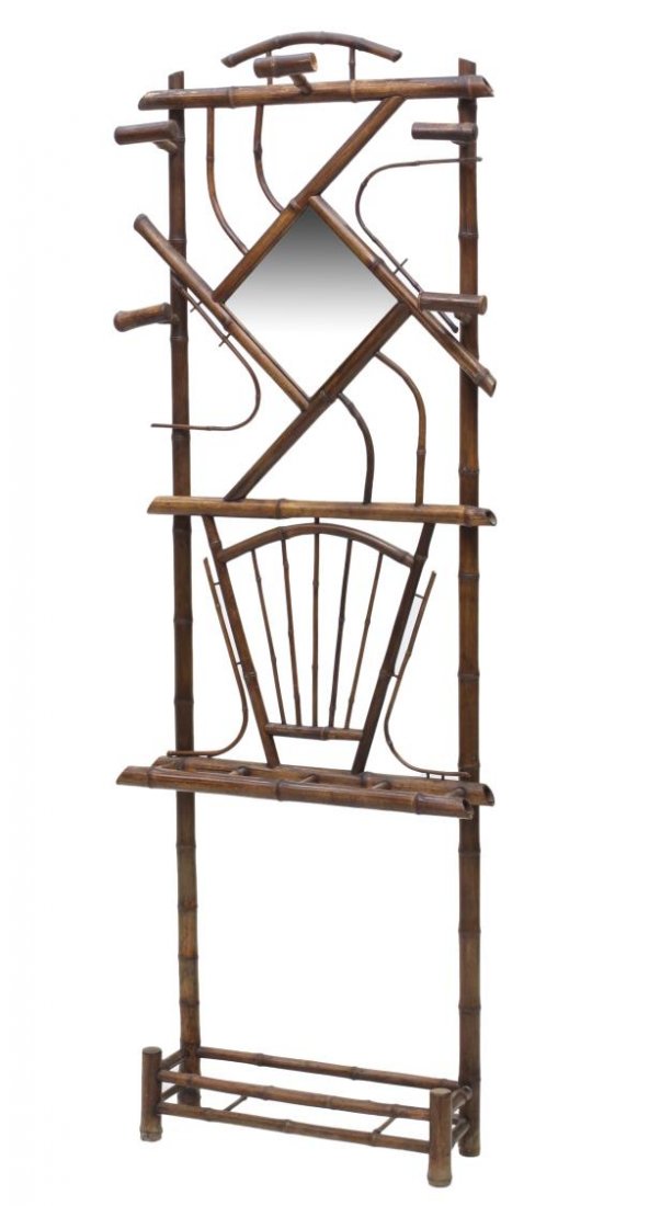 FRENCH ART DECO BAMBOO MIRRORED HALL TREE: French Art Deco bamboo hall tree, 1920's, having a shaped beveled mirror, coat hooks and lower umbrella rack, set on bamboo supports, 75"h, 28"w, 7"d *Provenance: Dreyfus Antiques, Austin, Texas* Star