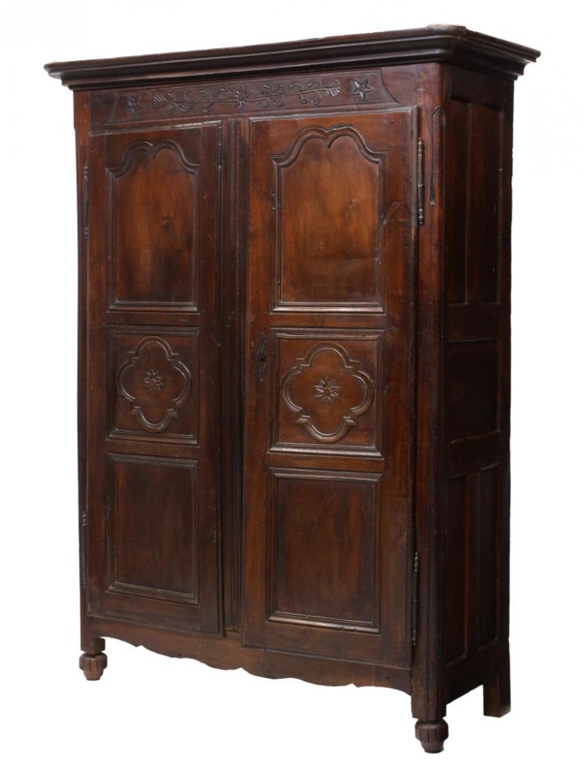 FRENCH LOUIS XVI 18TH C. ARMOIRE: French Louis XV armoire, late 18th c., the stepped cornice with a foliate and star carved frieze over two paneled doors with exterior hinges, all rising on ribbed ball feet, 82"h, 61"w, 24"d *Provenan