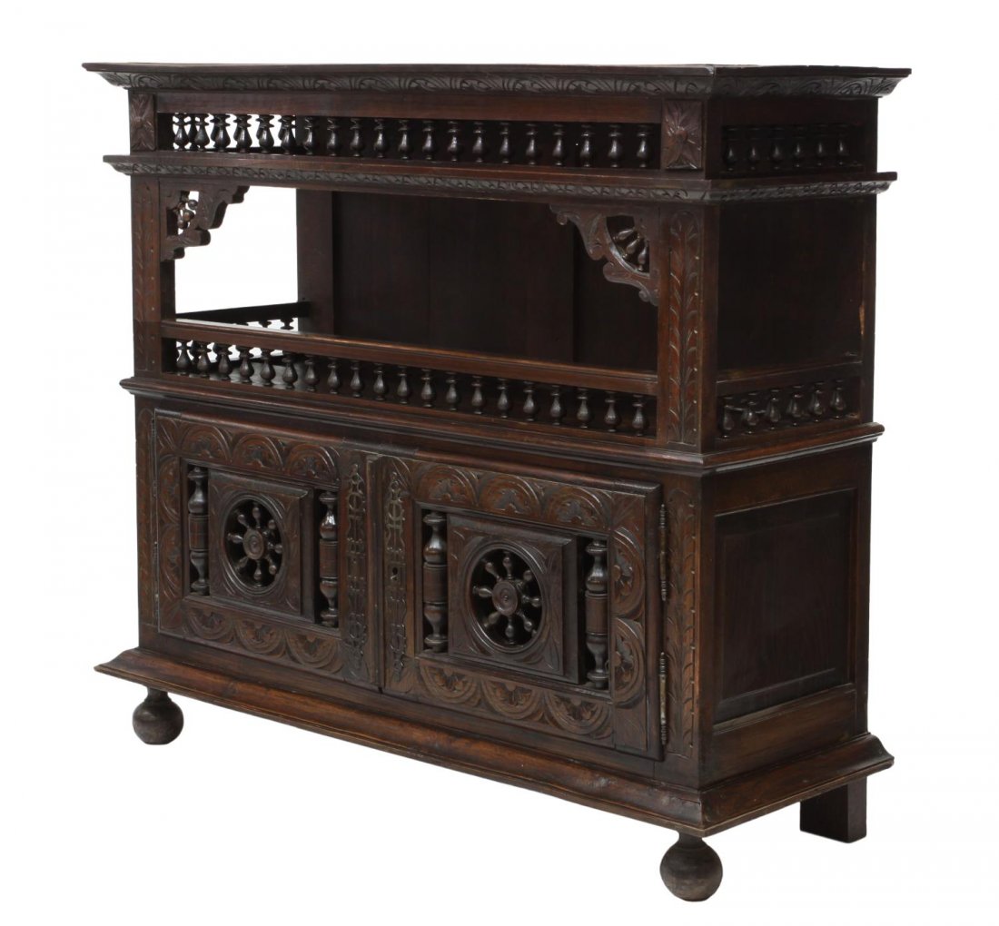 FRENCH BRETON HALL CABINET, 19TH C.: French Breton hall cabinet, 19th c., a protruding cornice over an open shelf with spindle rails at its' top, front and sides, two lower pierced, spindled and foliate carved doors, rising on the steppe