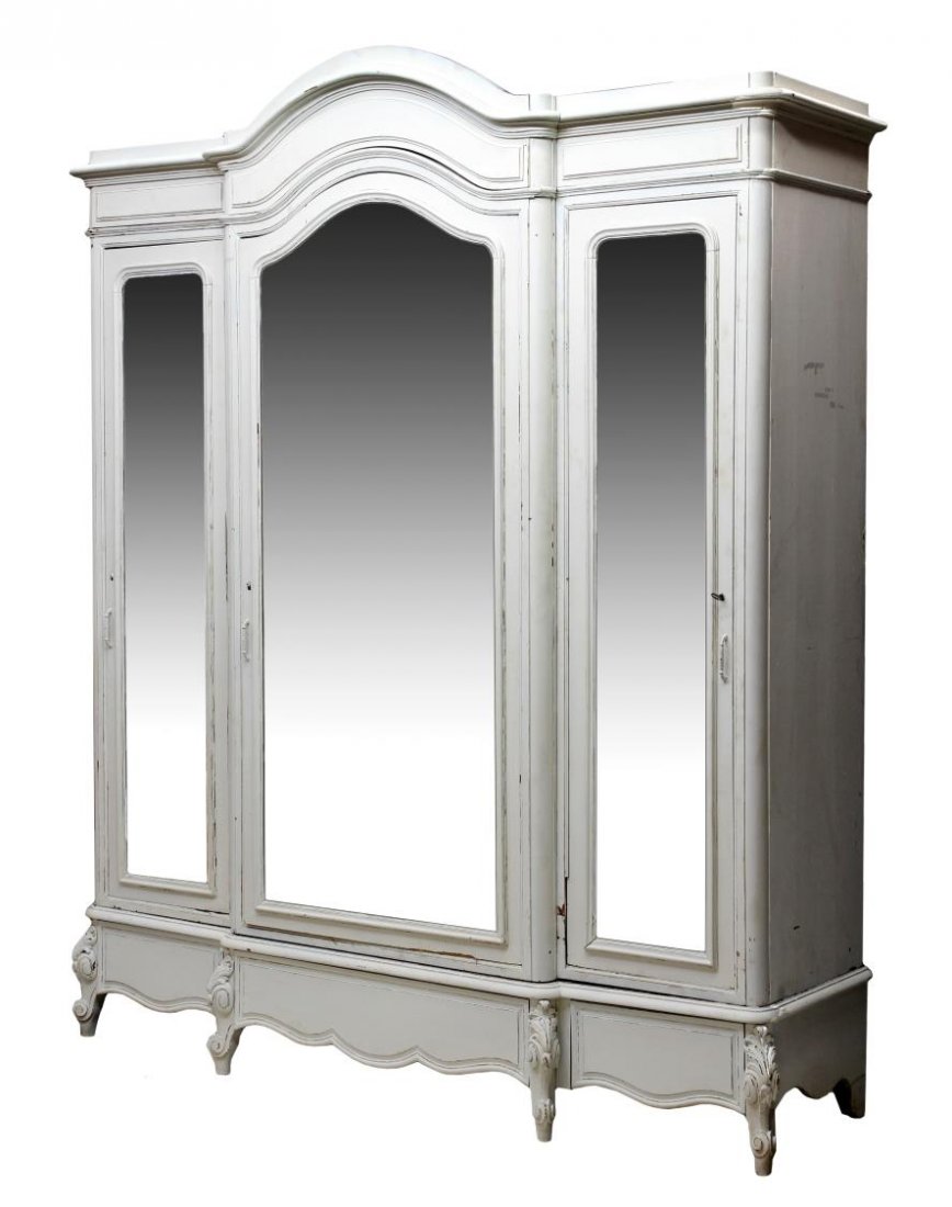 FRENCH LOUIS XV STYLE TRIPLE DOOR PAINTED ARMOIRE: French Louis XV style painted armoire, c. 1900, a faded light color paint with an arched cornice over three beveled mirror front doors, the two side doors opening inward to create a surround mirror ef