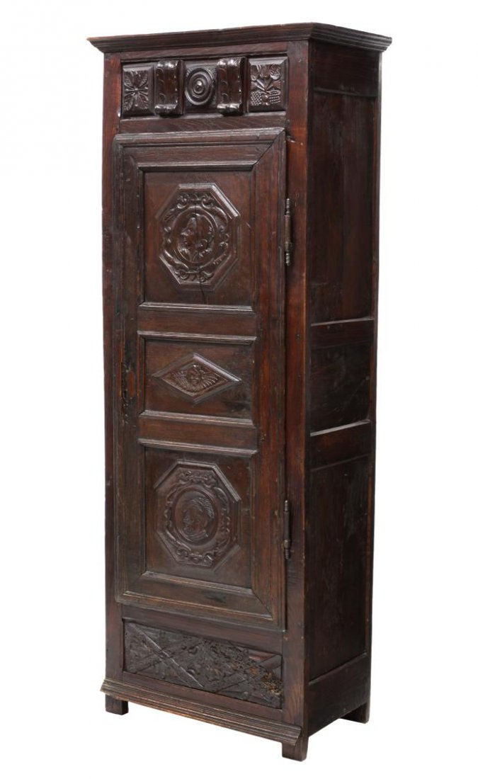 FRENCH PROVINCIAL CARVED BONNETIERE, 18TH C.: French Provincial bonnetiere, Lyon, last quarter 18th c., a stepped cornice over the foliate carved frieze, the single door with upper and lower figural carved panels, all rising on block feet, 73.25"
