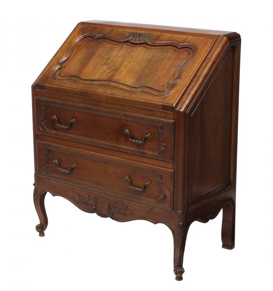 FRENCH LOUIS XV STYLE BUREAU: French Louis XV style bureau, 20th c., accented with foliate carving, the slant front opens to a leather writing surface and gallery, two exterior drawers, all rising on scroll foot cabriole legs, 39.