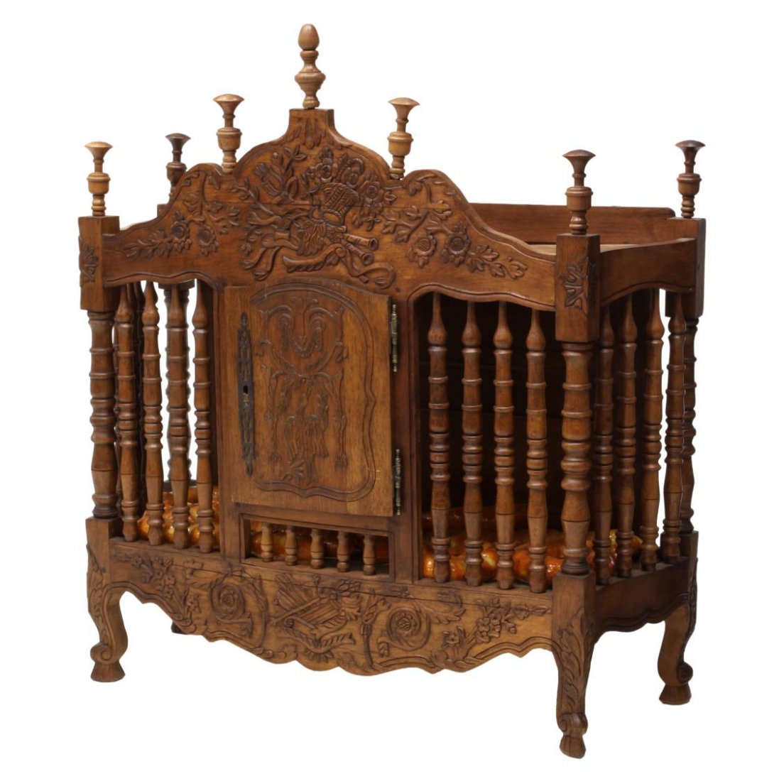 FRENCH PROVINCIAL WALNUT PANETIERE: French Provincial walnut hanging panetiere / bread box, late 19th c., the shaped crest with floral and basket carving above baluster and ring-turned spindles, a central door with ornate carving opens 
