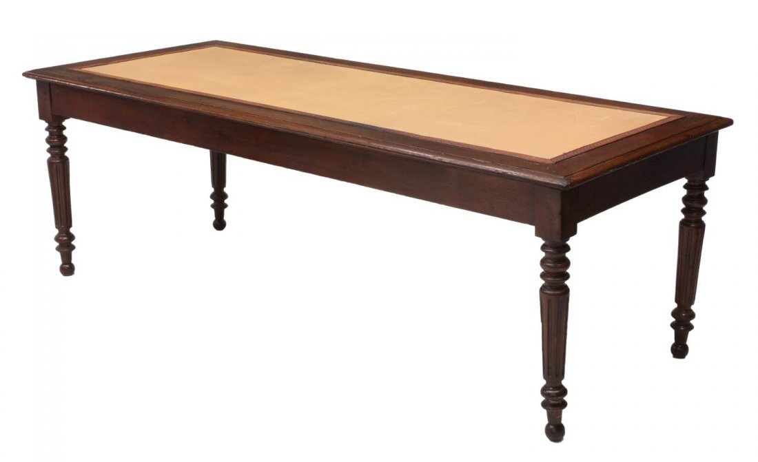 FRENCH OAK INSET LEATHER WORK TABLE: French oak work table, c. 1900, the rectangular top inset with leather, rising on ribbed supports with turned feet, 29"h, 84.5"w, 35.25"d *Provenance: Dreyfus Antiques, Austin, Texas* Start Price: $15