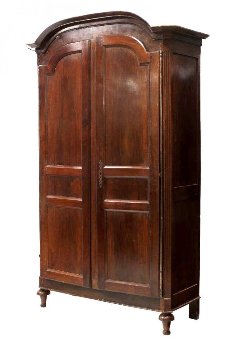 ANTIQUE FRENCH MAHOGANY PANELED DOOR ARMOIRE: French mahogany armoire, early 19th c., having a chapeau top over two paneled doors on long exposed hinges opening to the interior with a shelf over two drawers, all rising on turned supports, approx.