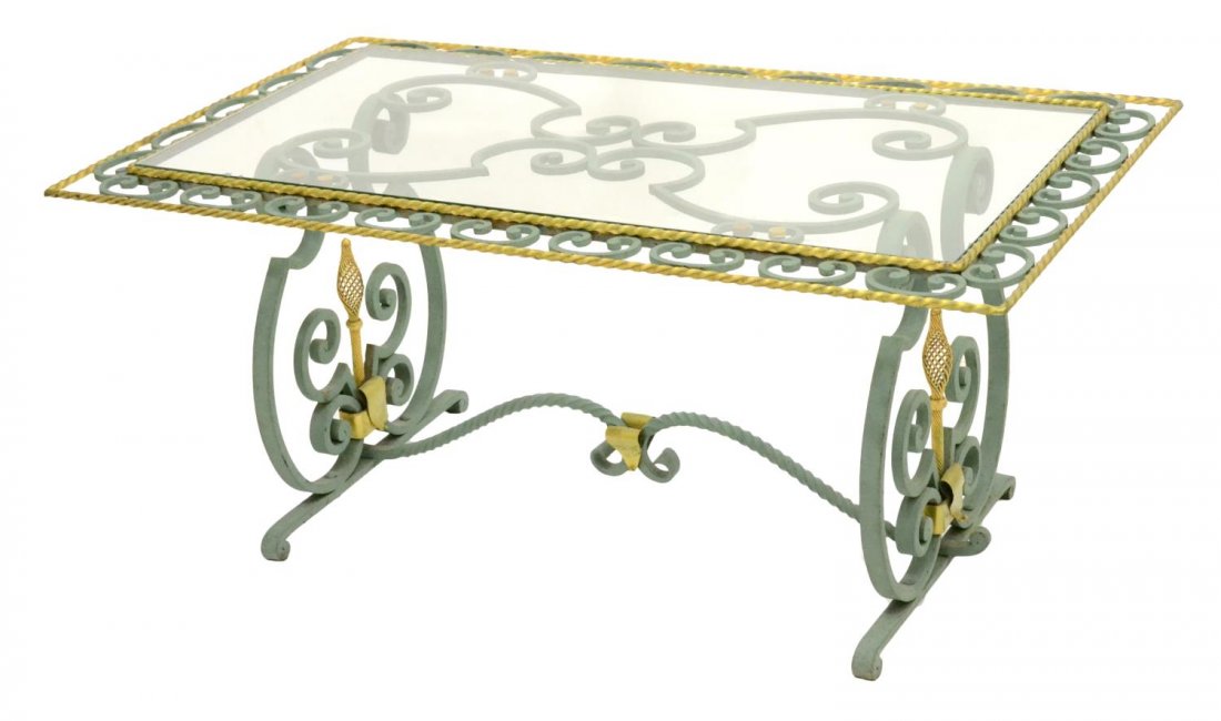 FRENCH GILT IRON & GLASS COFFEE TABLE, 20TH C.: French gilt iron and glass coffee table, 20th c., rectangular glass table top framed by parcel gilt and twisted scroll accents, rising on trestle base, minor loss to gilding, flakes to glass, approx 2