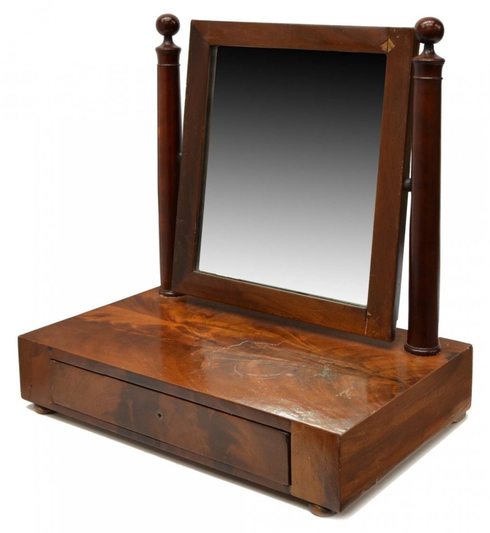 FRENCH EMPIRE STYLE MAHOGANY SWING MIRROR: French empire style mahogany swing mirror table top vanity, the rectangular mirror having two simple column supports, above the plain case with single drawer, rising on bun feet, lacking drawer pull, 