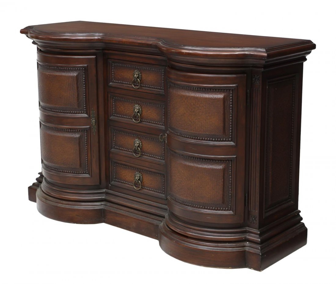 CONTEMPORARY BAR CABINET, 20TH C.: Contemporary bar cabinet, shaped top over front with three drawers flanked by two cabinets, each drawer and cabinet door having brass lion masque pull handles on woven panels framed by brass tacks, on