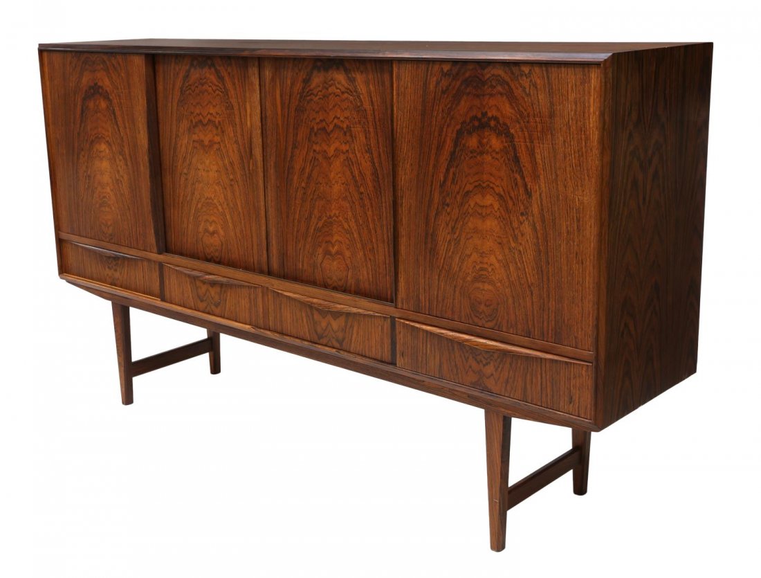 DANISH MID-CENTURY MODERN ROSEWOOD SIDEBOARD: Danish mid-century modern rosewood sideboard, c. 1950s/1960s, the rectangular case having sliding doors fitted with shelves and drawers, above four concealed drawers, rising on tapered legs, 45"h, 77.